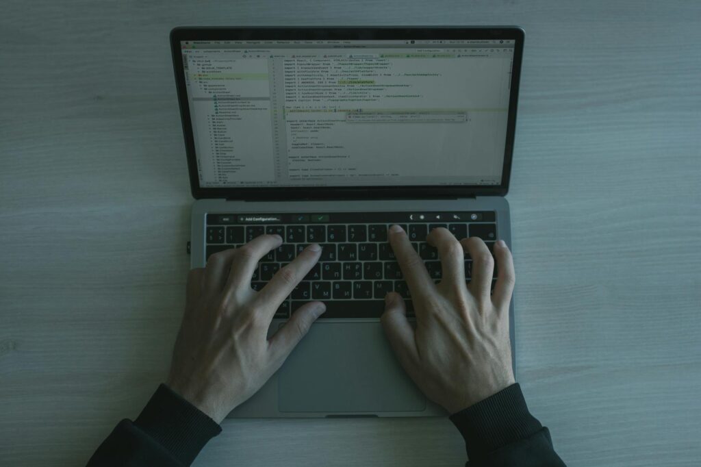 developer coding laptop, AI coding assistant software, programmer workspace